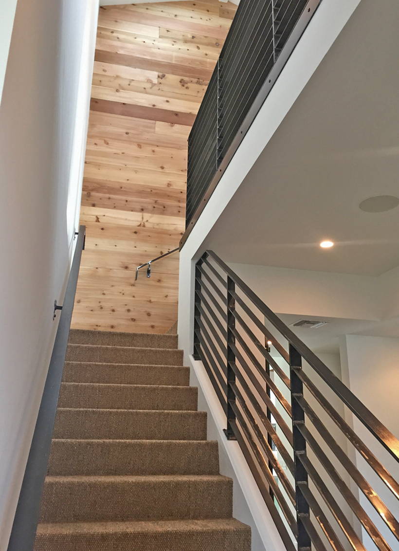 Stairway at the Palm Modern Farmhouse with industrial mill scale steel hand rails and guard rails.